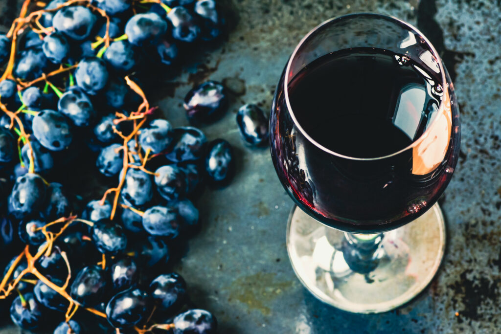 red wine beside red grapes