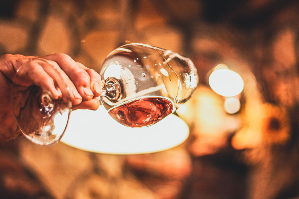 wine glass being held up to a light
