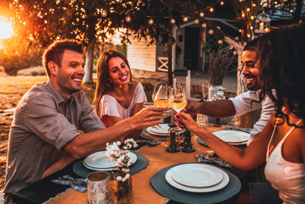 friends clinking glasses outdoors